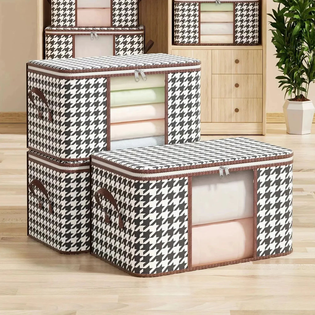 A stack of two black and white houndstooth patterned fabric storage boxes with transparent front windows for clothes