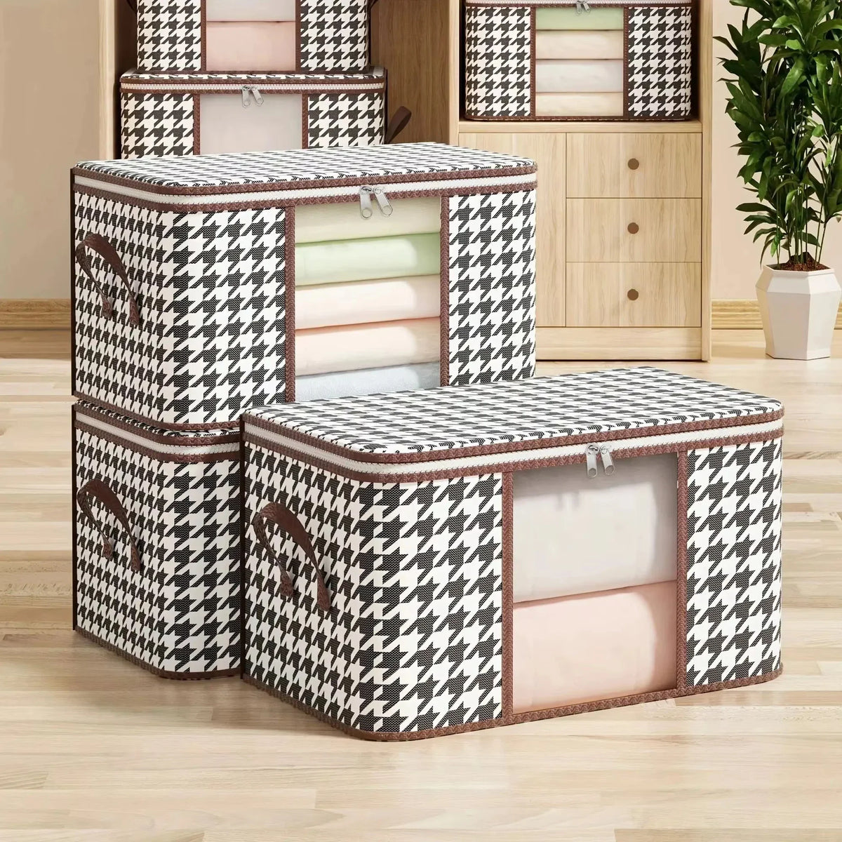 A stack of two black and white houndstooth patterned fabric storage boxes with transparent front windows for clothes