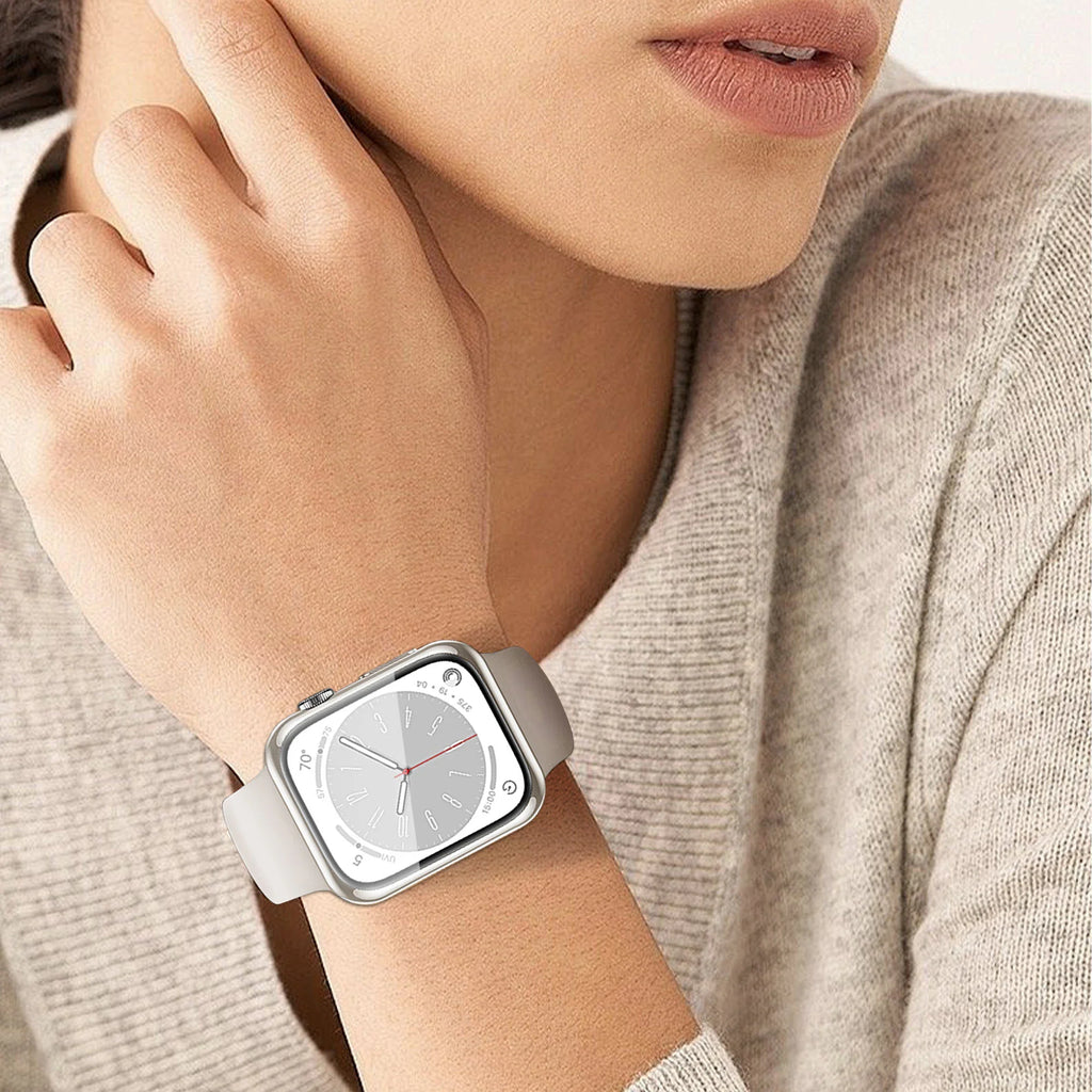 A person wearing a silver smartwatch with a clear protective bumper case on their wrist.
