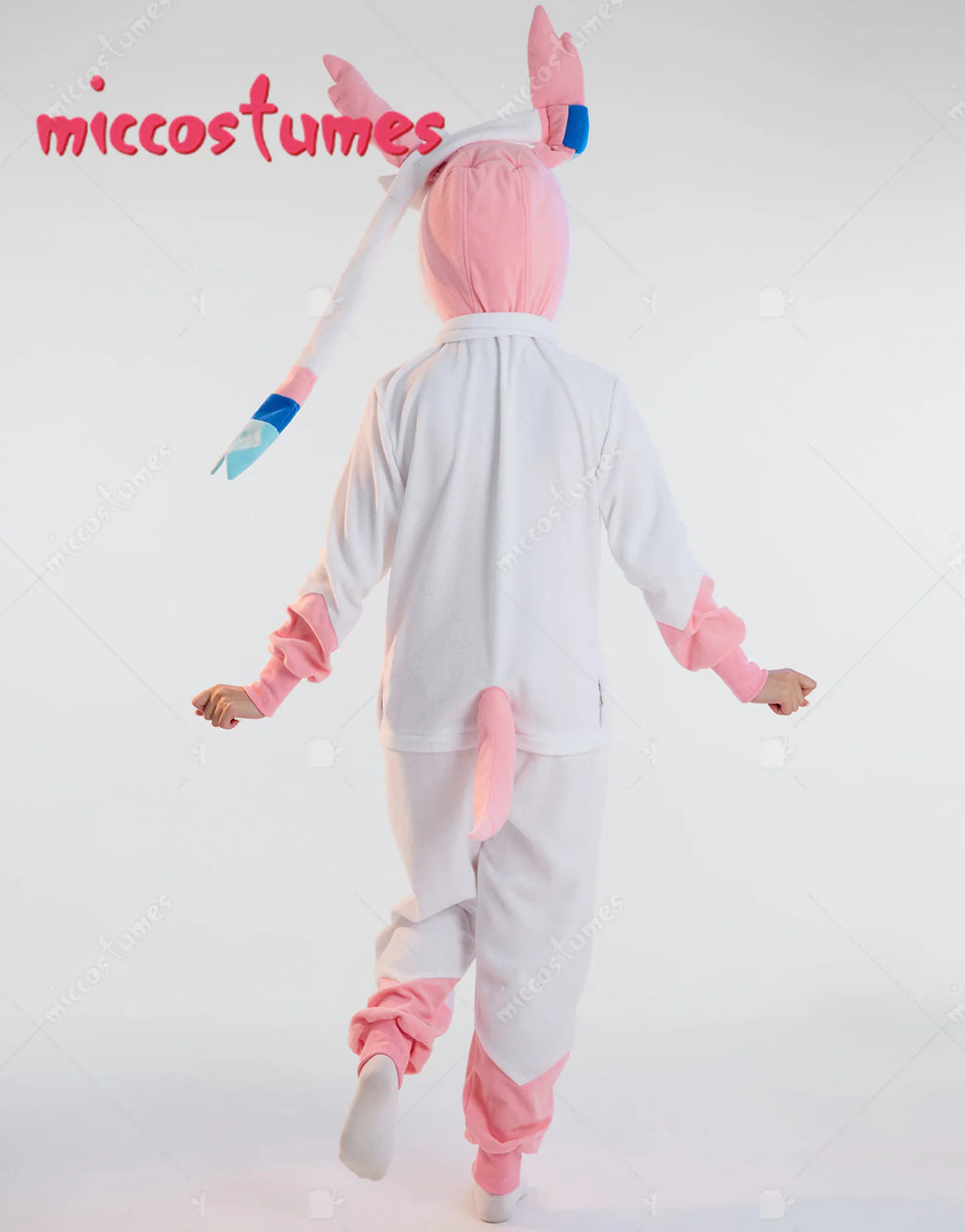 Back view of a white and pink hooded onesie pajama with a tail
