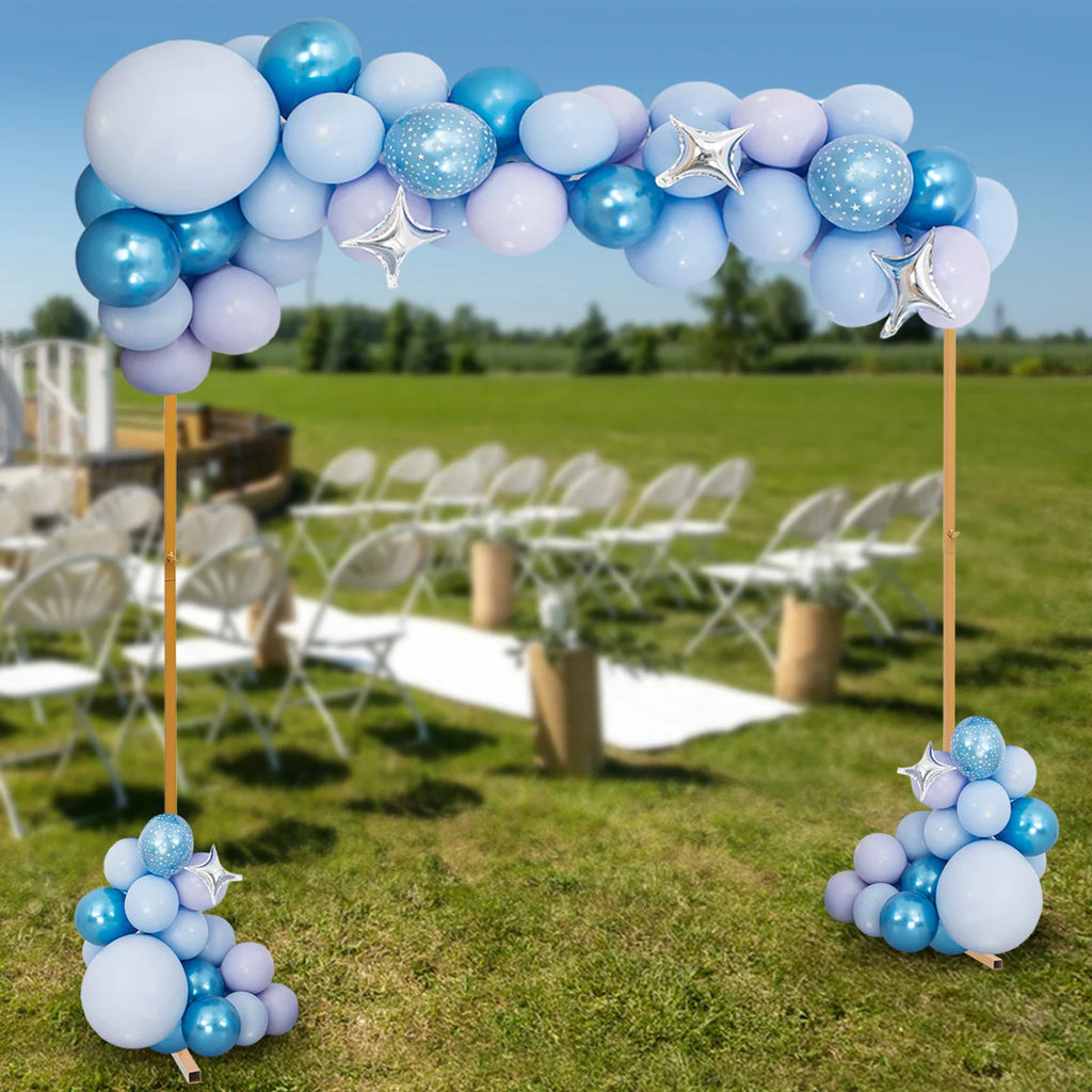 Golden square arch stand decorated with blue and silver balloons in a field