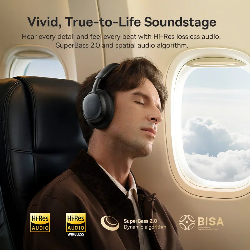 A man wearing black wireless headphones on an airplane