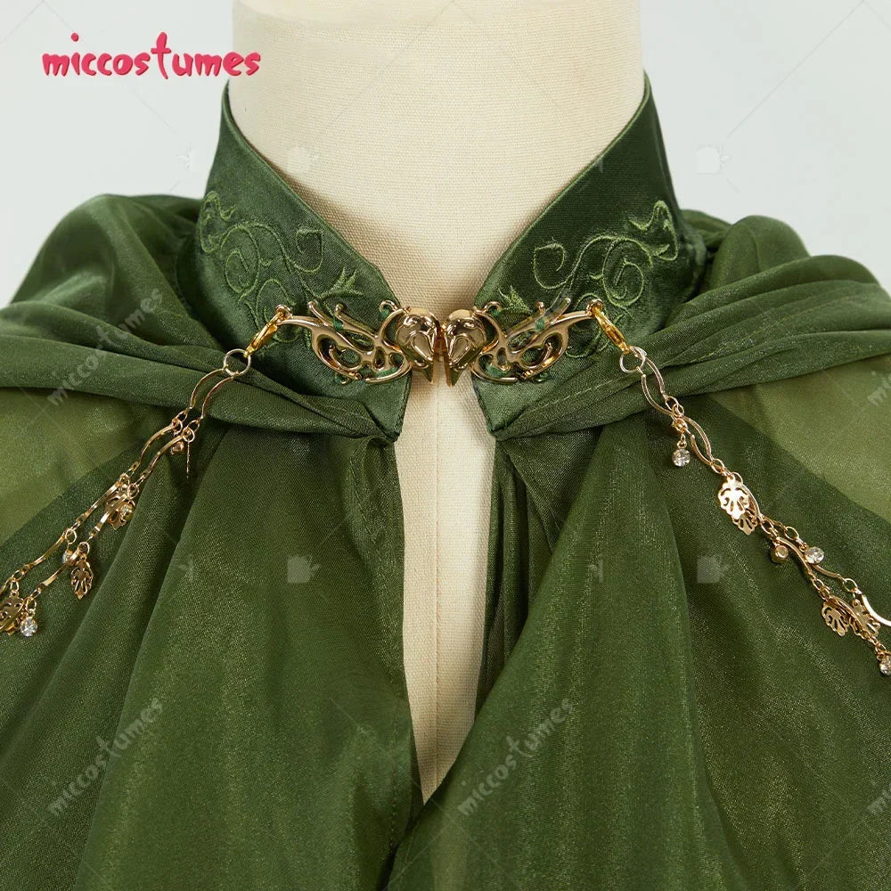 Close up of an embroidered collar and ornate gold metal clasp on a green hooded cloak