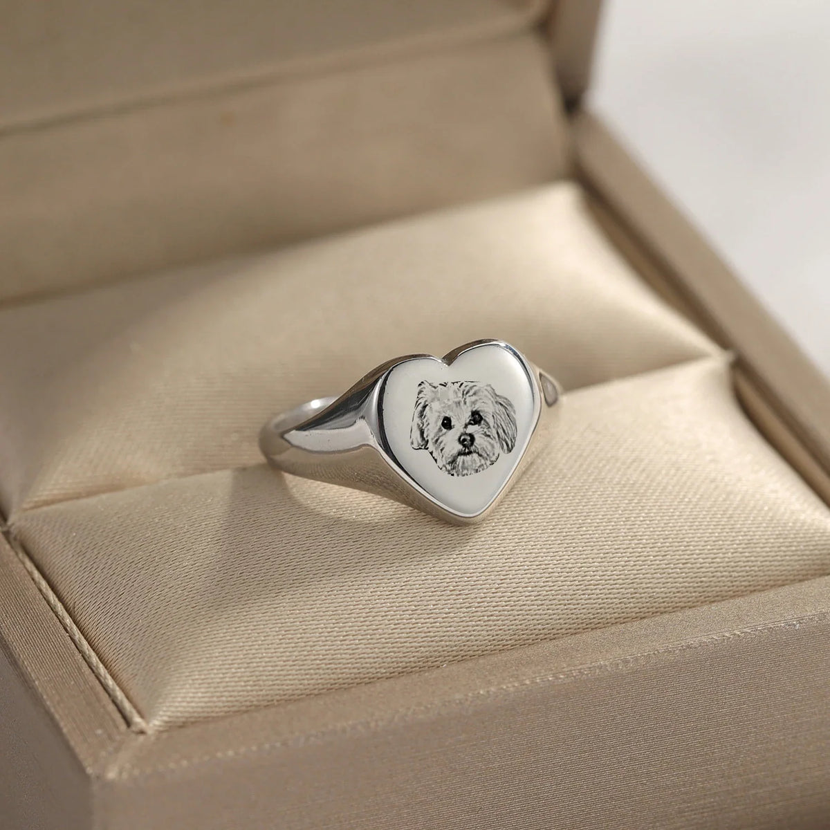 Silver-toned heart signet ring featuring a custom engraved dog portrait in a jewelry display box