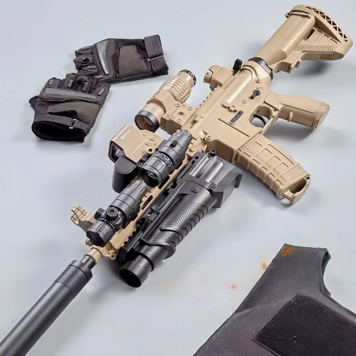 Tan M416 gel blaster toy with gloves and protective gear.