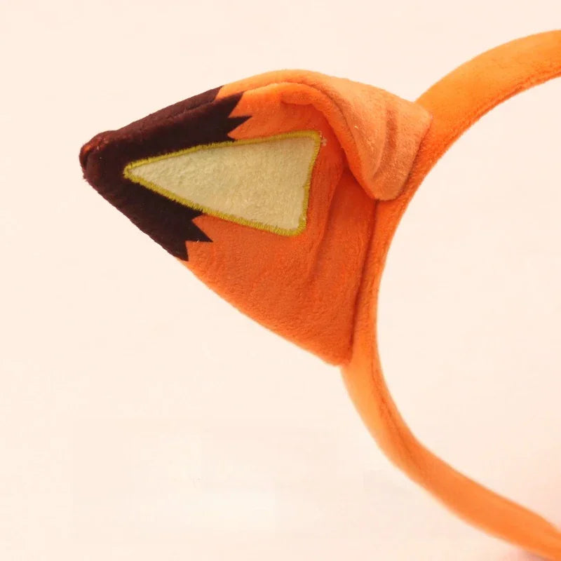 Close up of an orange plush fox ear on a headband.