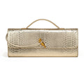 Gold metallic faux crocodile skin long clutch bag with a top handle and gold knot clasp