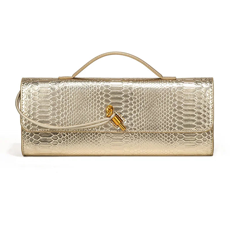 Gold metallic faux crocodile skin long clutch bag with a top handle and gold knot clasp