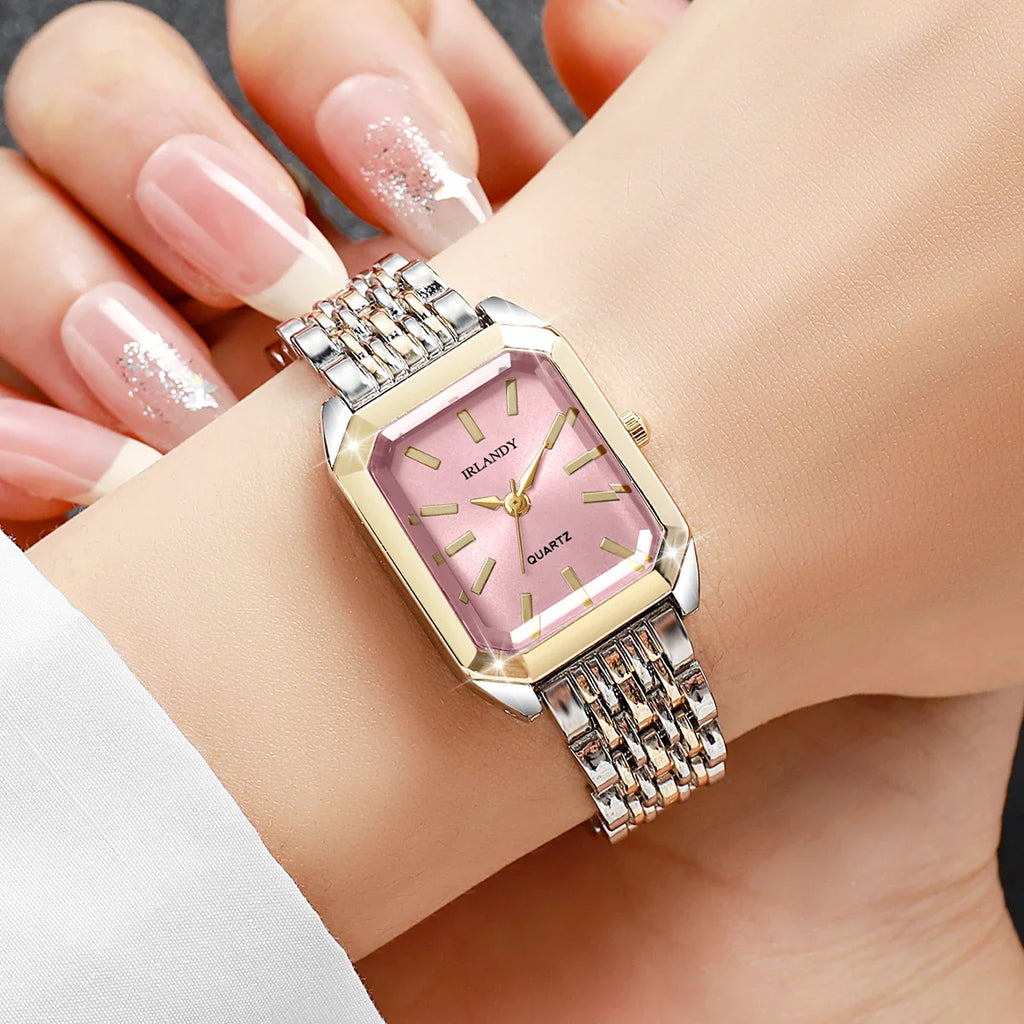 Two-tone rectangular women's quartz watch with a pink dial worn on a wrist