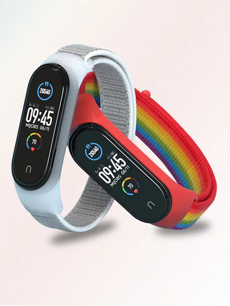 Two fitness tracker bands featuring rainbow-colored nylon straps with digital interfaces