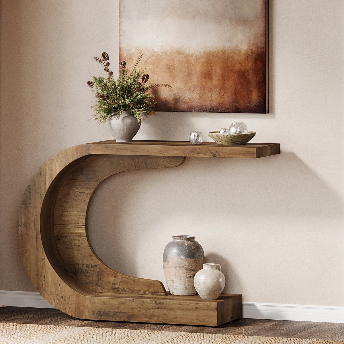 Curved rustic wood console table with decorative vases against a wall.