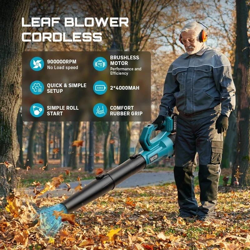 A person using a teal cordless leaf blower to clear autumn leaves in a park.