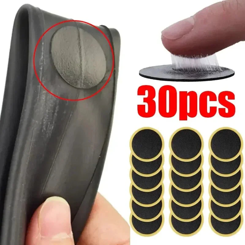 A set of 30 round self-adhesive black bicycle tire repair patches for inner tubes.