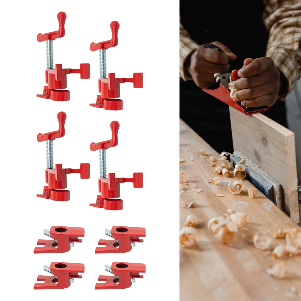 Red pipe clamp set with a hand tool working on wooden board.