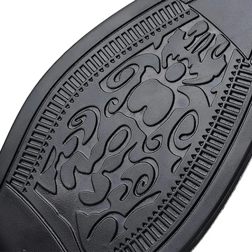 Detail close-up of the textured patterned rubber sole of a black mens dress shoe.