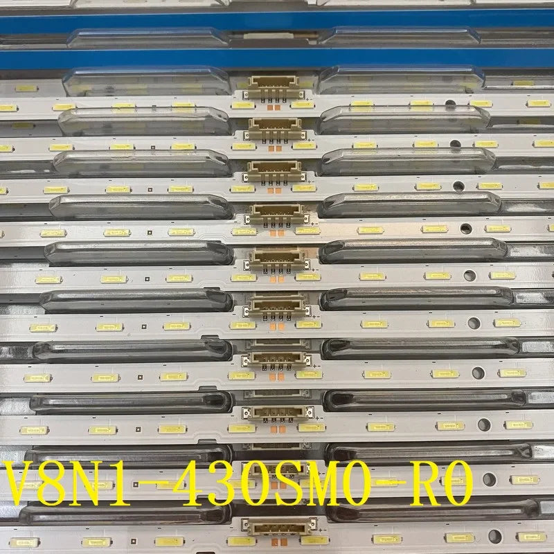 Several rows of LED backlight strips organized in a clear plastic shipping tray