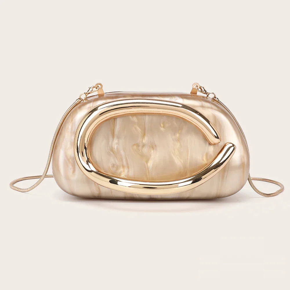 A beige marble-effect evening clutch with a gold-tone metallic oval ornament and a thin chain shoulder strap.