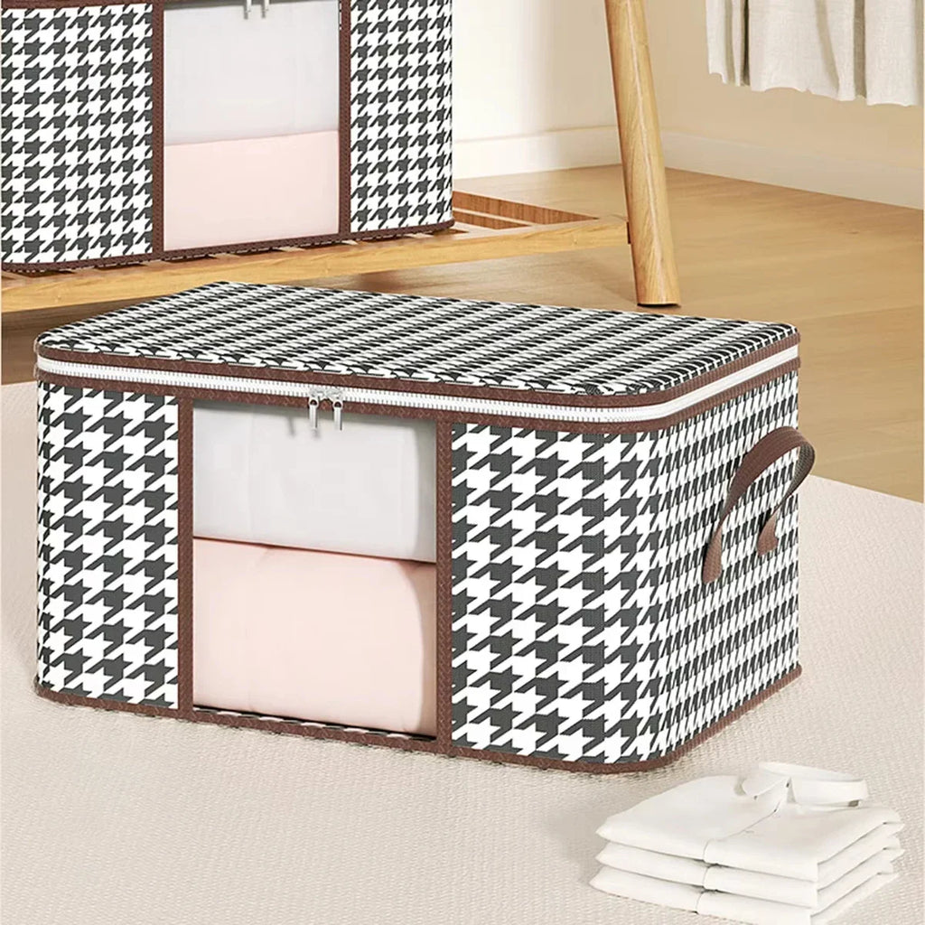 A single black and white houndstooth patterned fabric storage box with a clear front window for organizing linens