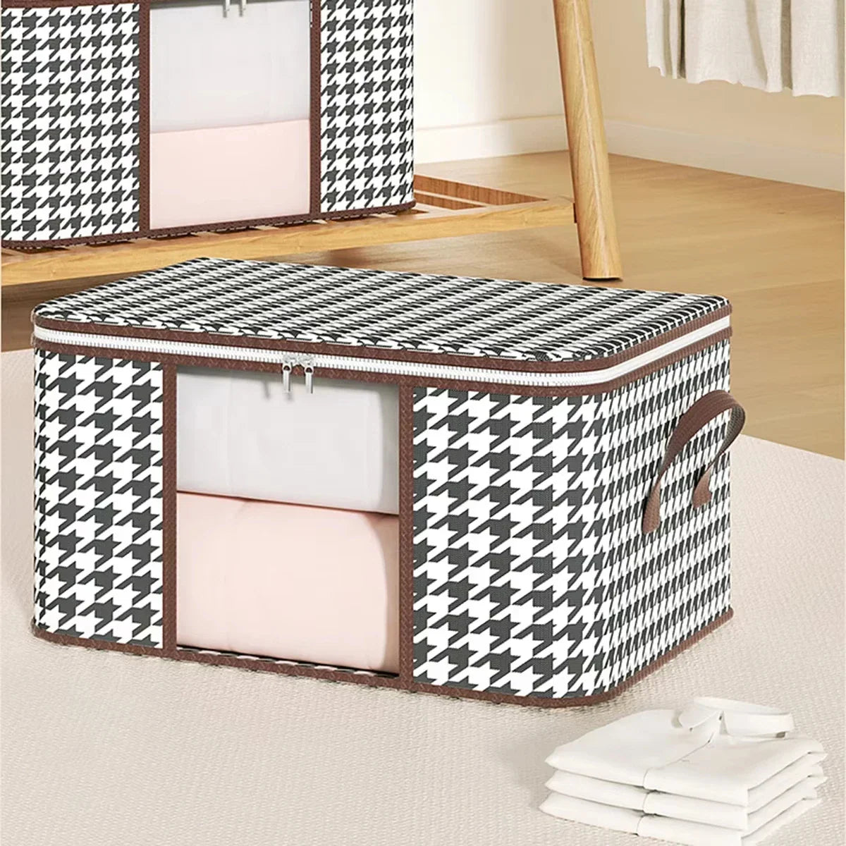 A single black and white houndstooth patterned fabric storage box with a clear front window for organizing linens