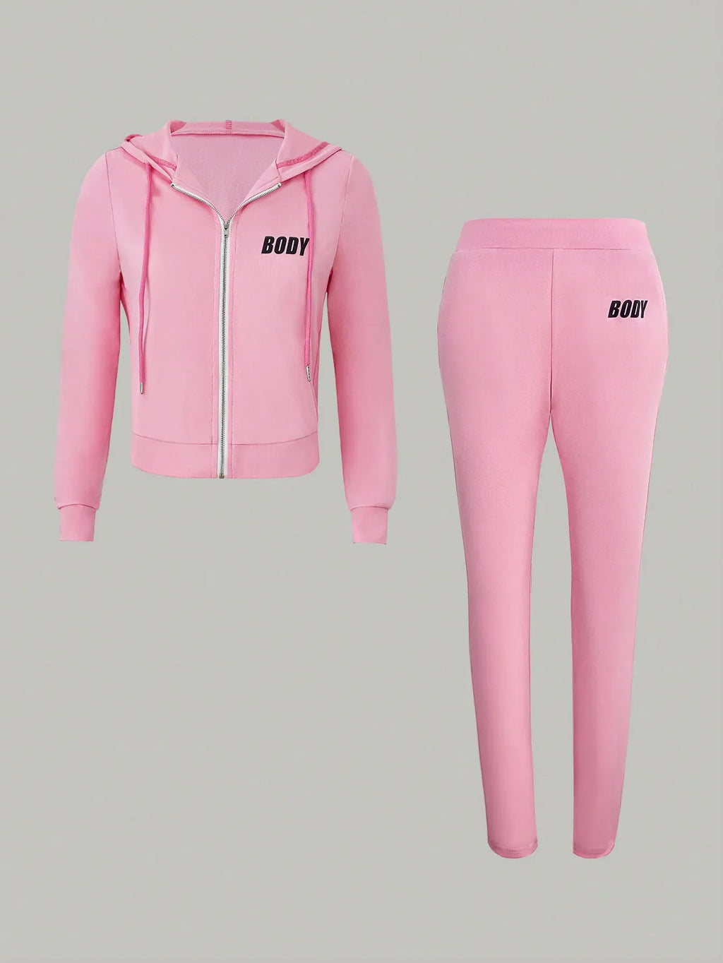 A pink two-piece set featuring a zippered hooded sweatshirt and matching sweatpants with printed black text.