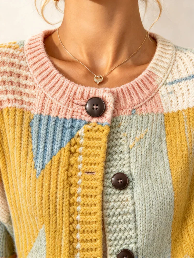 Close up of a collar and buttons on a multi-colored patchwork knit sweater