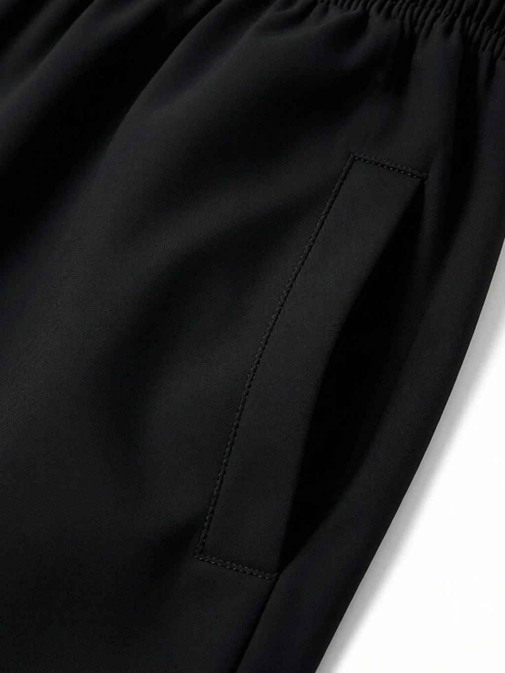 Close-up of side pocket detail on black athletic shorts