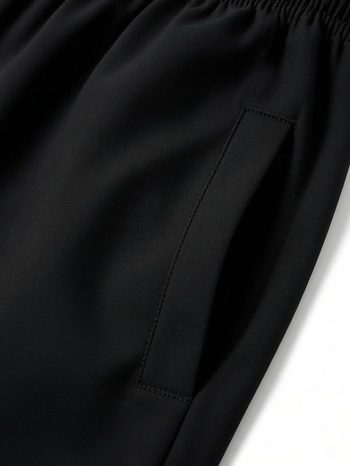 Close-up of side pocket detail on black athletic shorts