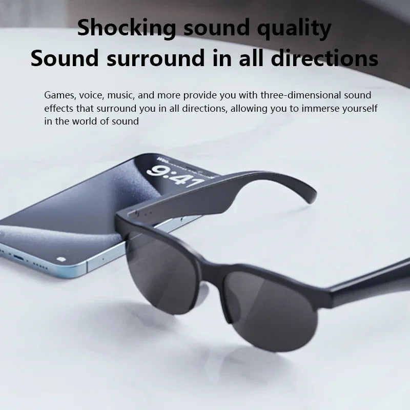 Black smart sunglasses placed on a white surface next to a smartphone