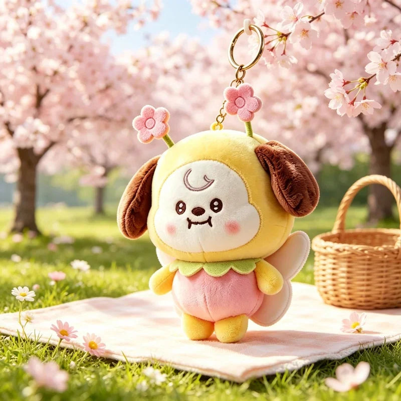 Plush puppy character keychain with flower antennas in a cherry blossom park