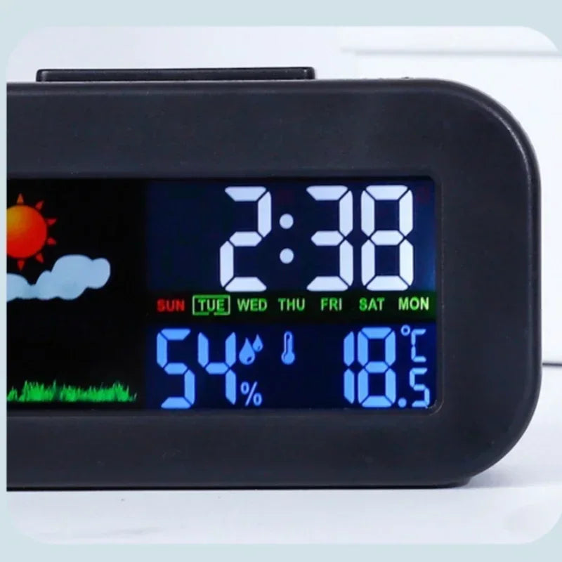 Digital desk alarm clock with weather and temperature display within a soft rounded frame