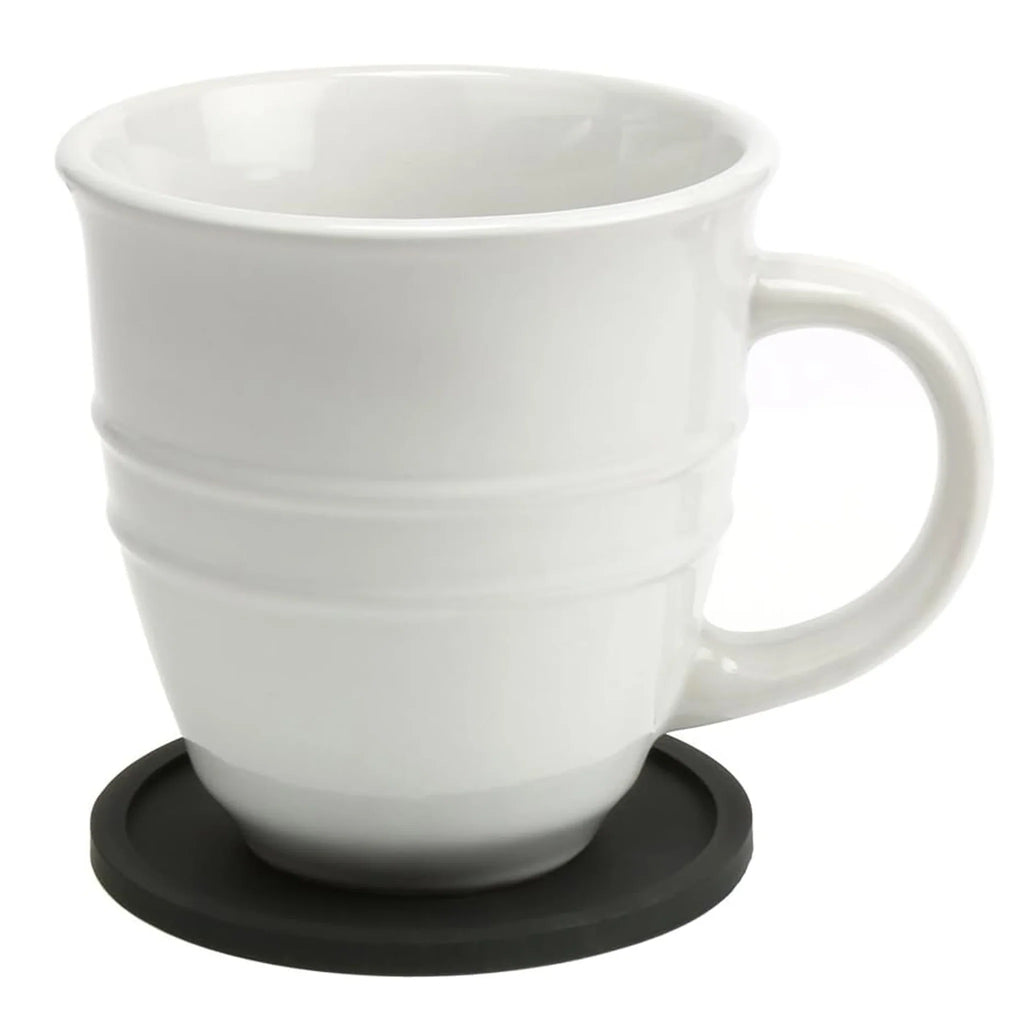 White ceramic mug on a round black silicone coaster
