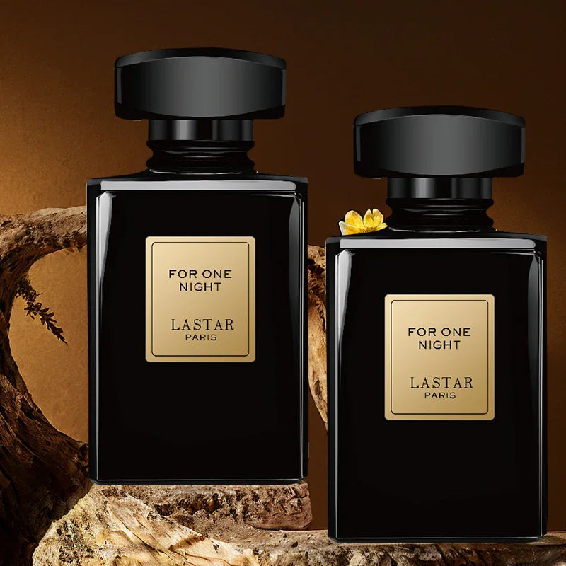 Two black perfume bottles placed on rustic wood against a dark brown background.
