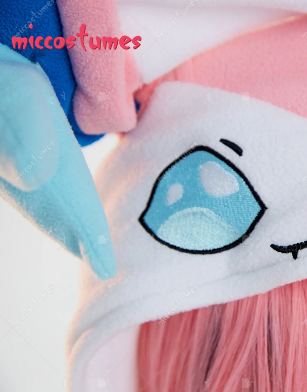 Close up detail of a hooded animal onesie with embroidered eye