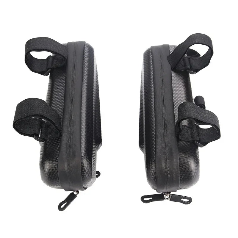 Top view of two black motorcycle side bags showing zippers and mounting straps