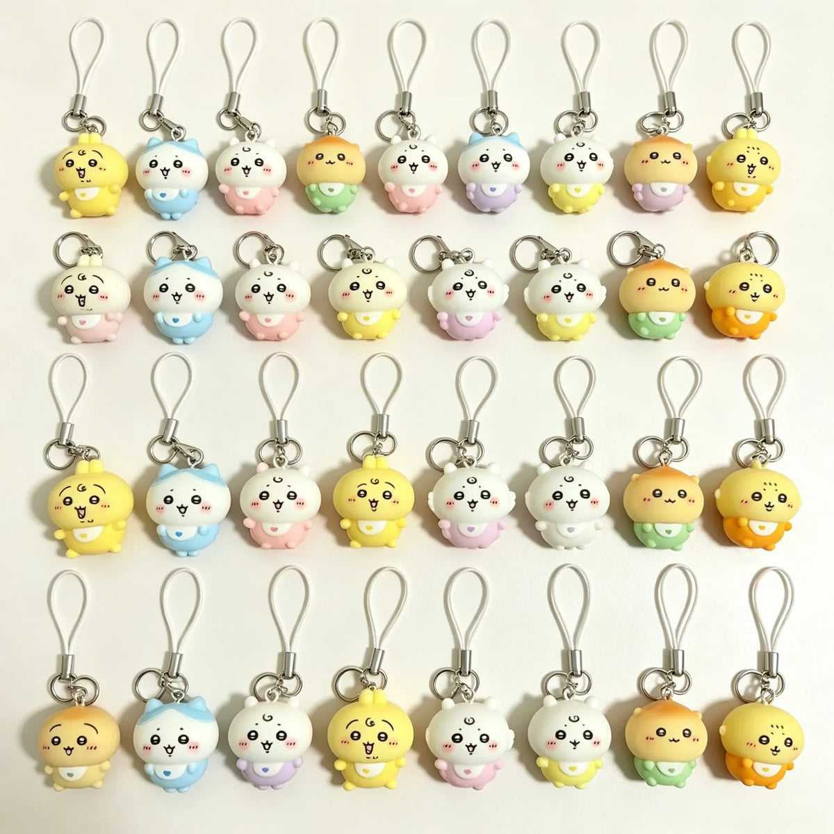 A collection of colorful resin character charms for phones and bags, featuring various animal designs with lanyards.