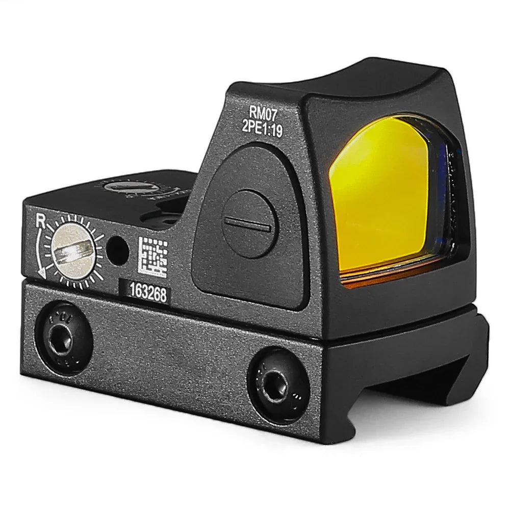 Black miniature red dot reflex sight side view with yellow lens