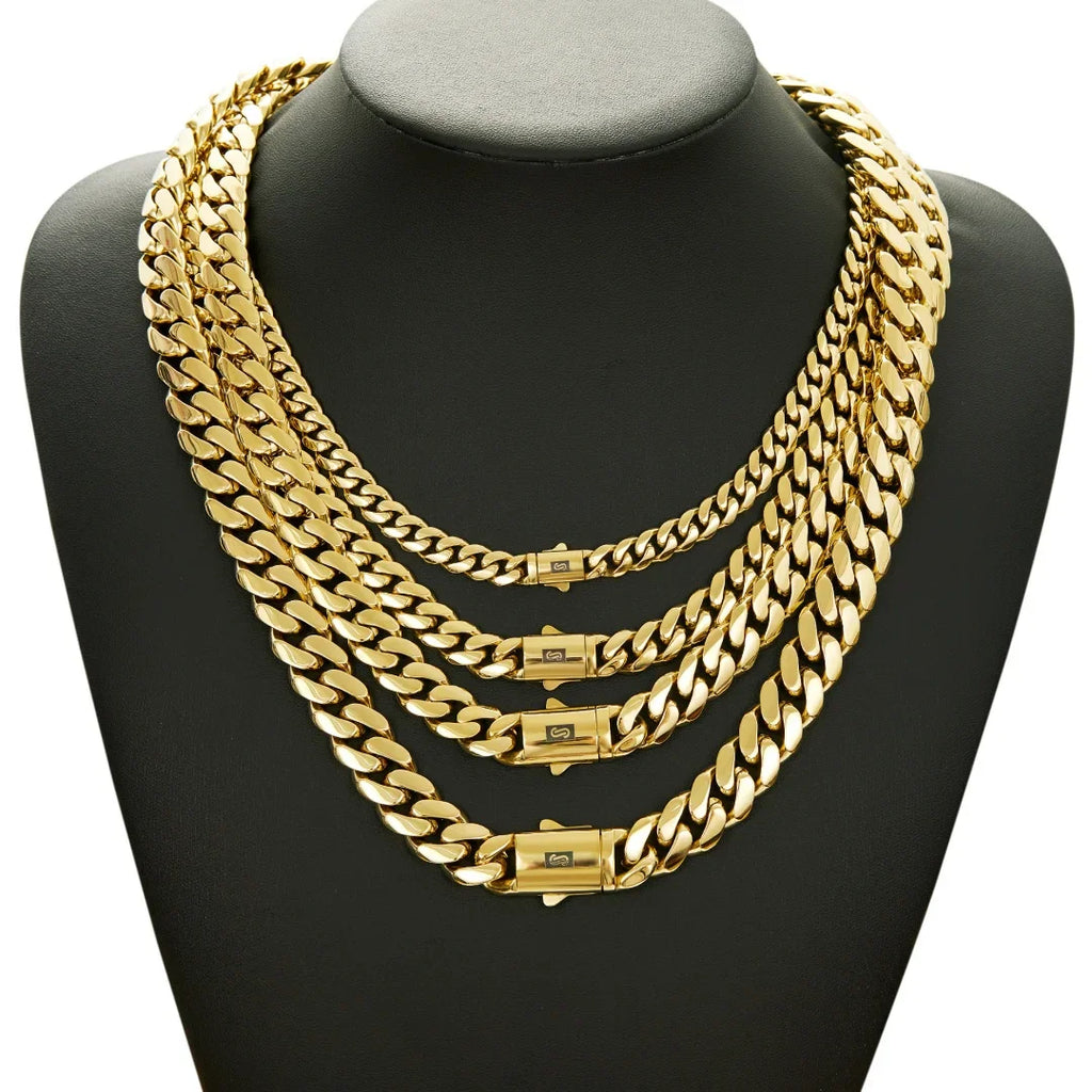 Four different widths of gold cuban link chains layered on a black display bust