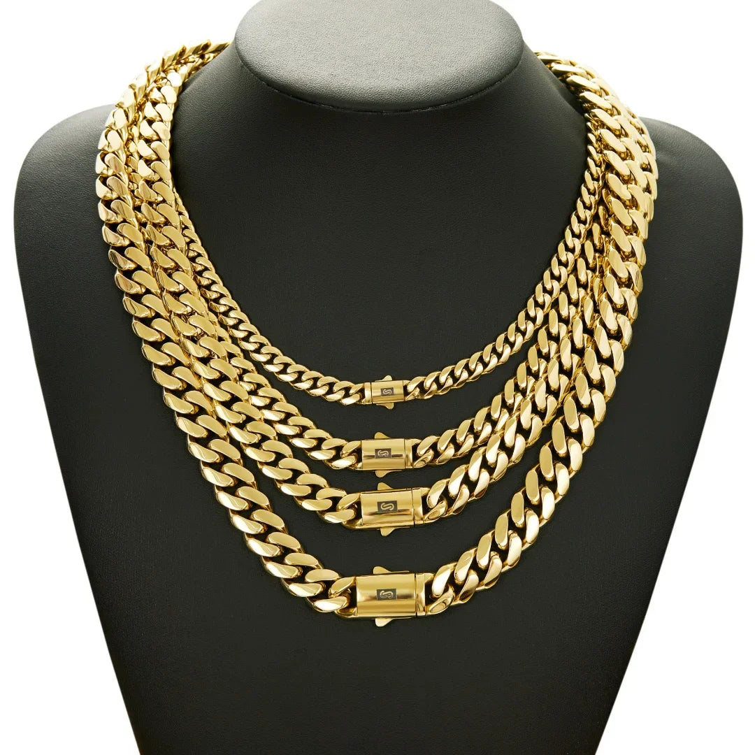Four different widths of gold cuban link chains layered on a black display bust