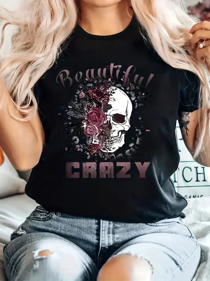 Black short sleeve t-shirt with floral skull graphic and text on a woman
