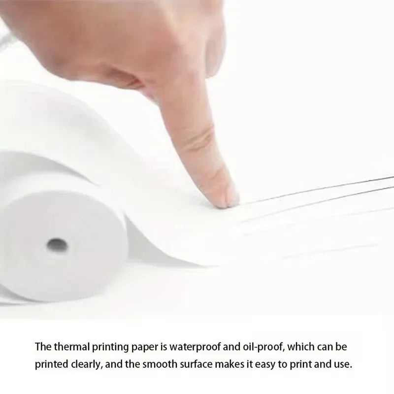 Close up of a hand holding a roll of smooth white thermal printing paper