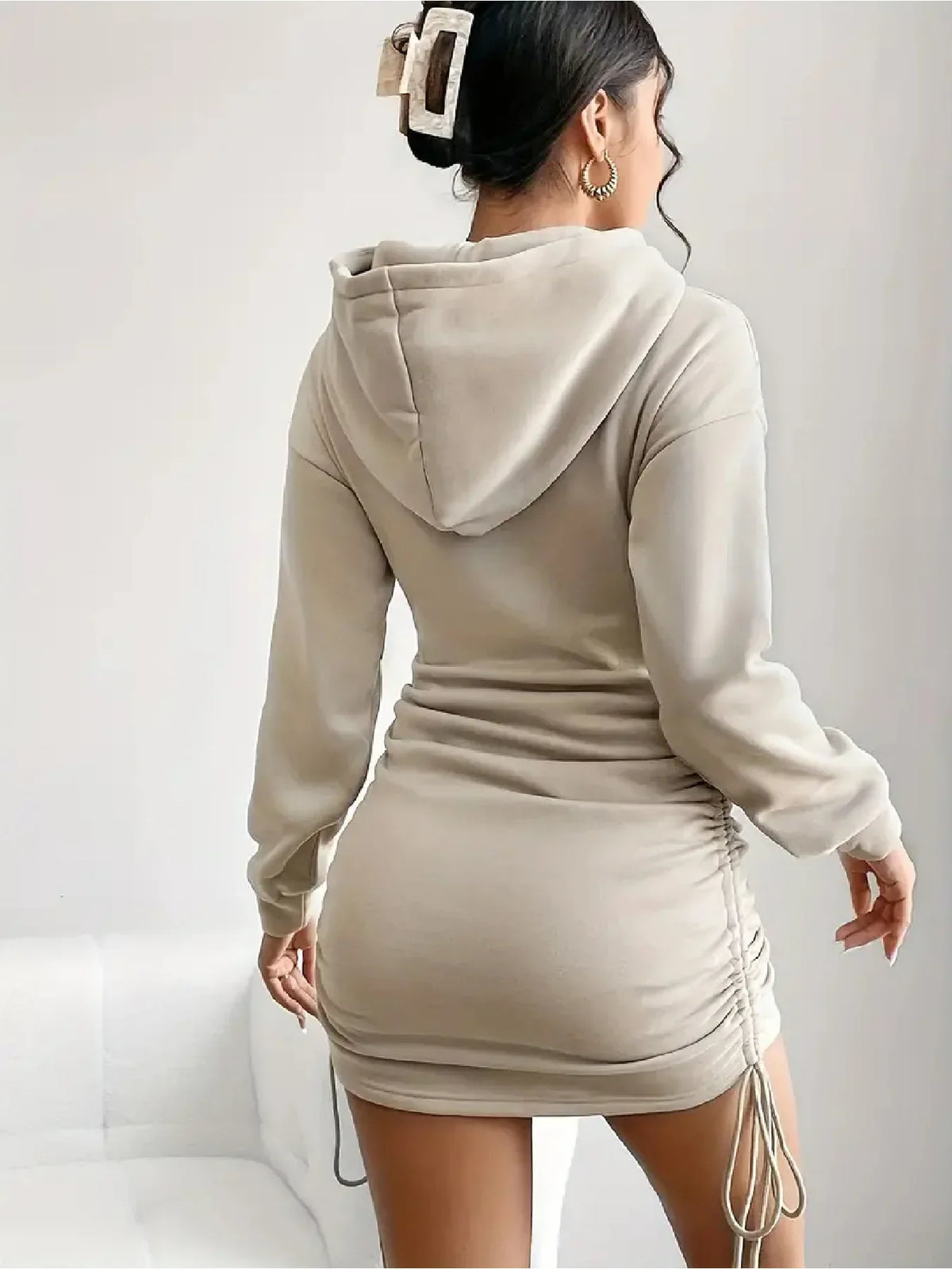Back view of beige long-sleeve hooded drawstring mini dress