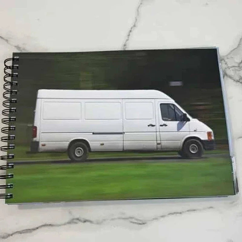 Spiral-bound sketchbook showing a white van in a park on the page