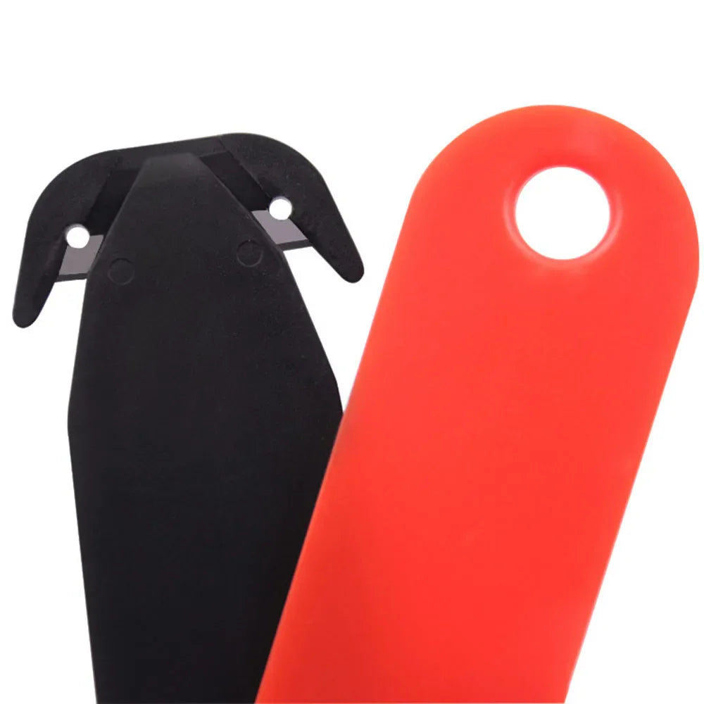 Close up of a black and red double-edged plastic safety box cutter.