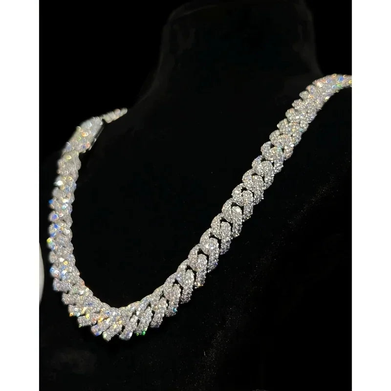 Men's heavy Cuban link chain necklace covered in sparkling moissanite stones on a black display bust