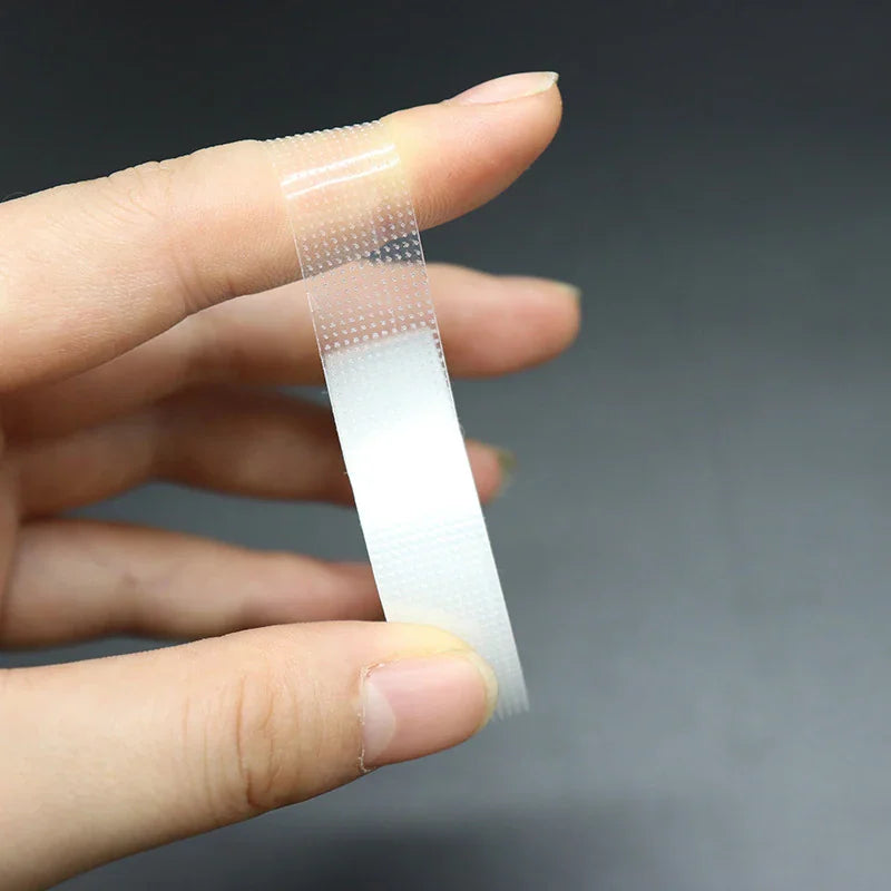 Transparent micropore tape being applied to a finger for eyelash extensions