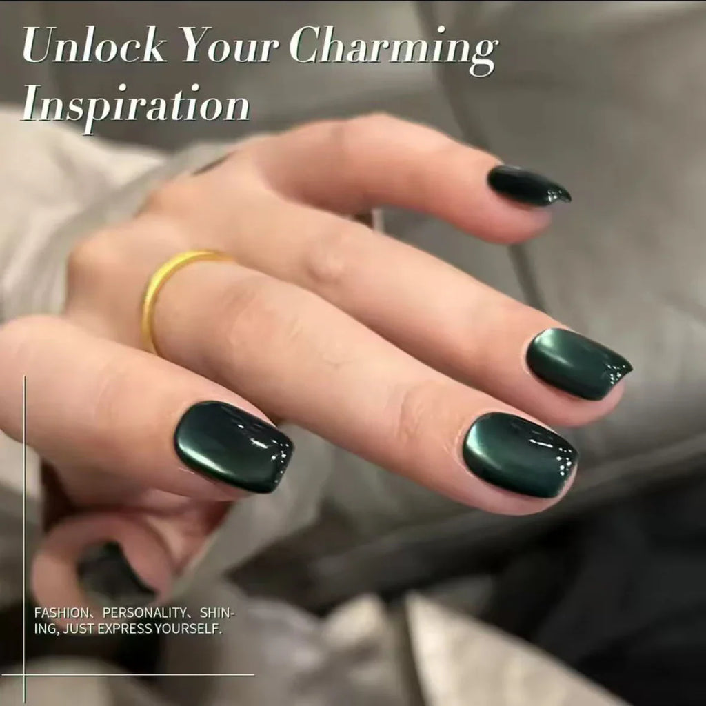 Hand with glossy dark green cat eye magnetic gel nails