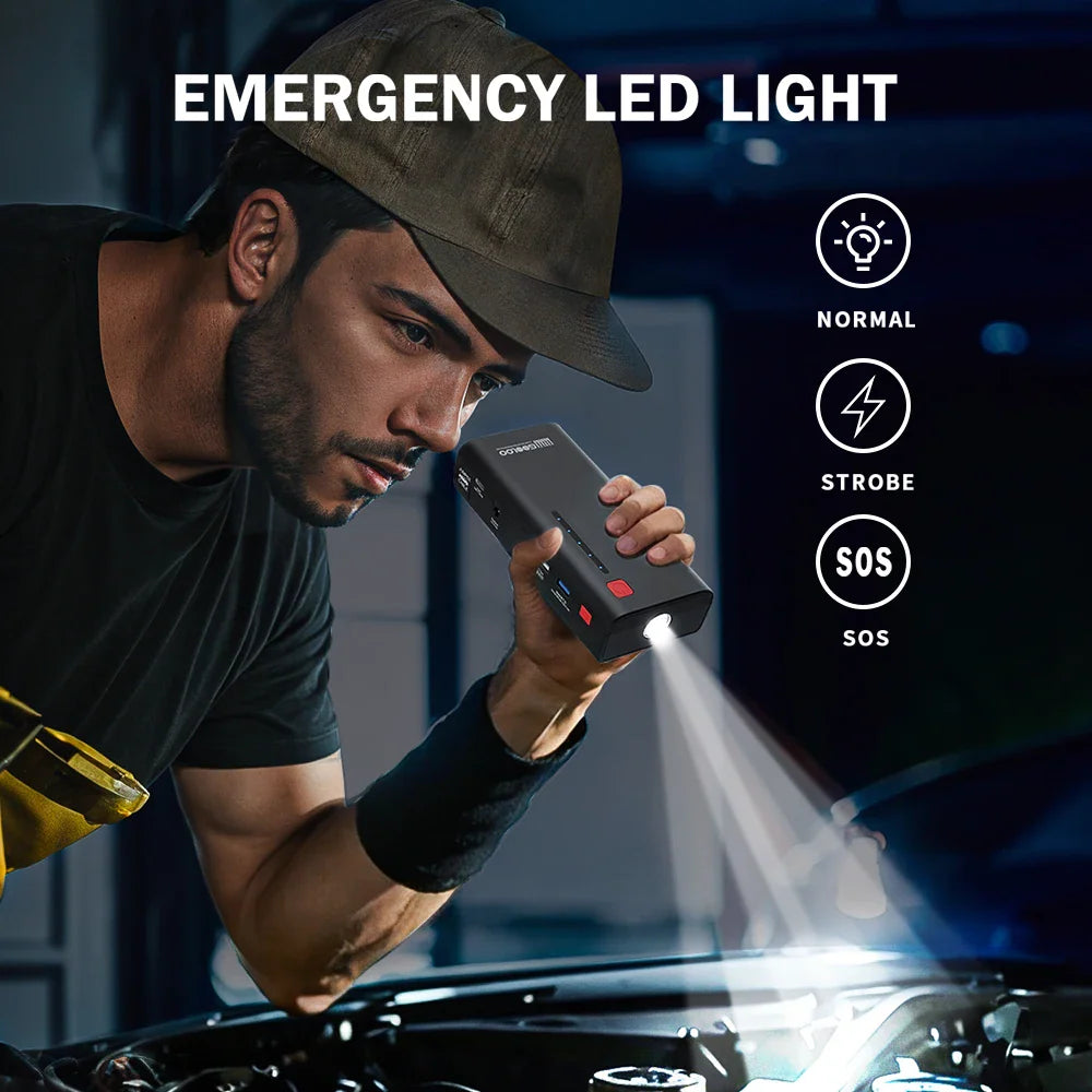 Man using a black portable jump starter with an emergency led flashlight at night