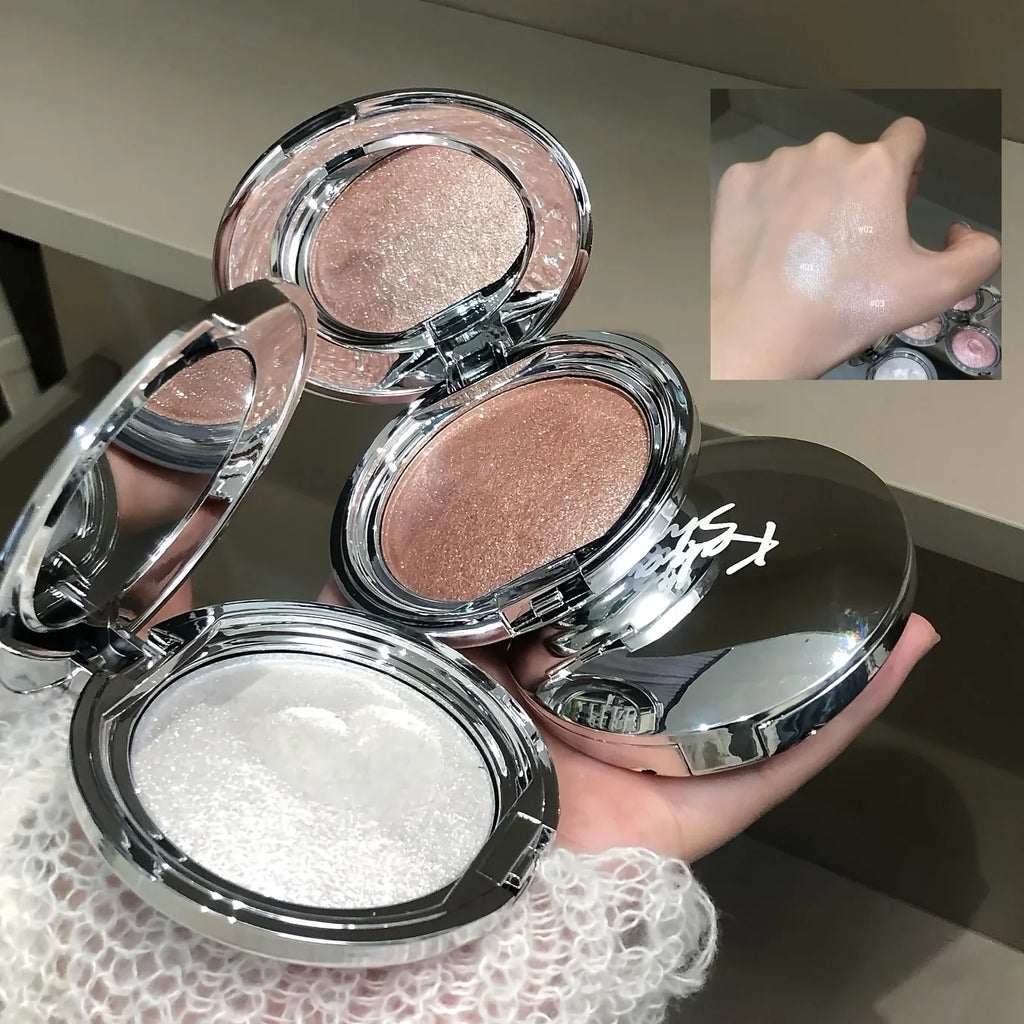 Two shimmer highlighter compacts in silver packaging with hand swatches