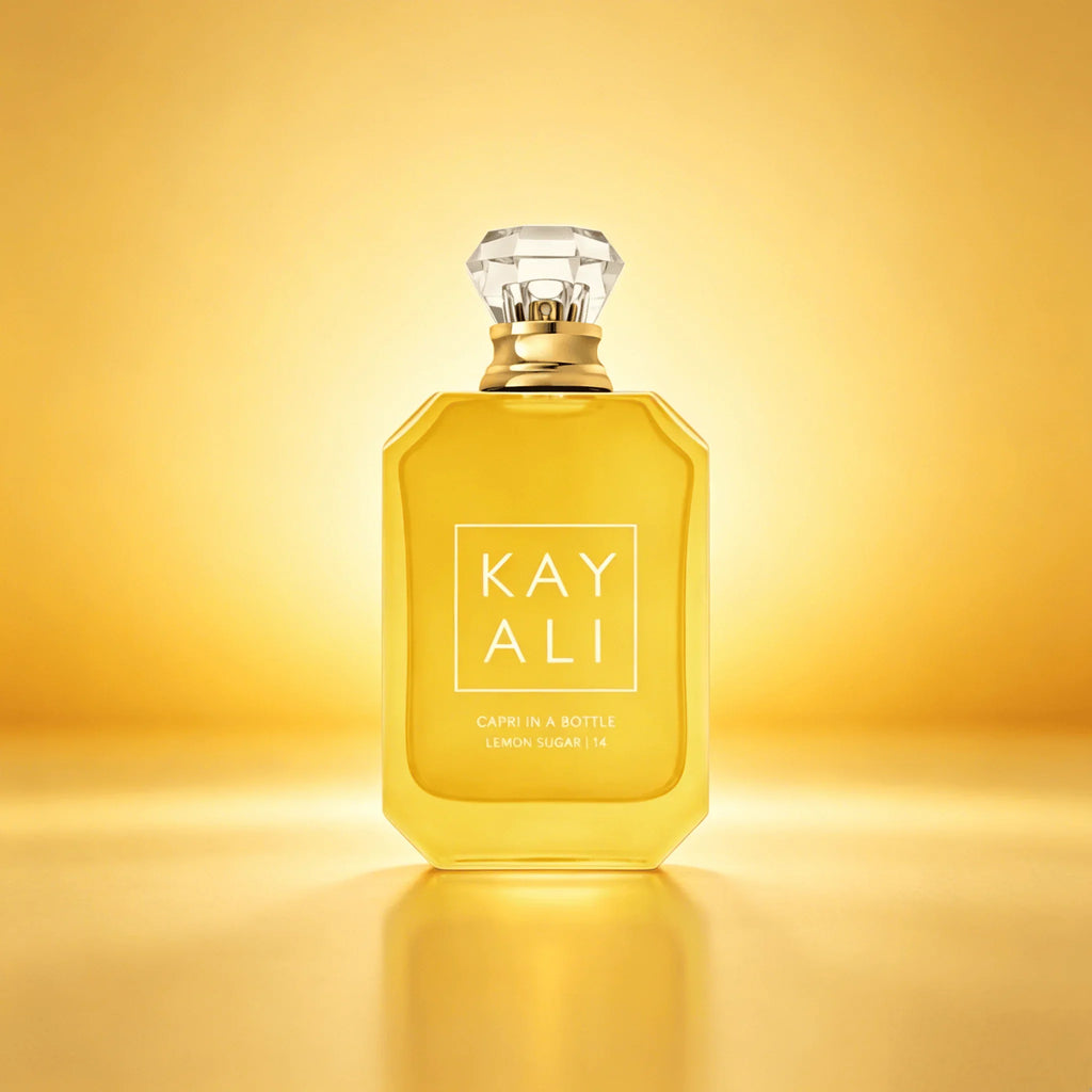 Bottle of lemon sugar scented perfume on a golden yellow background