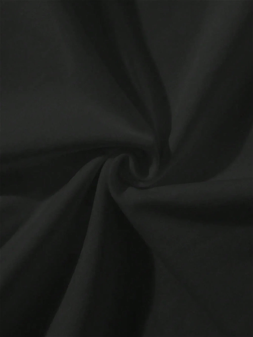 Close-up of gathered black textile material
